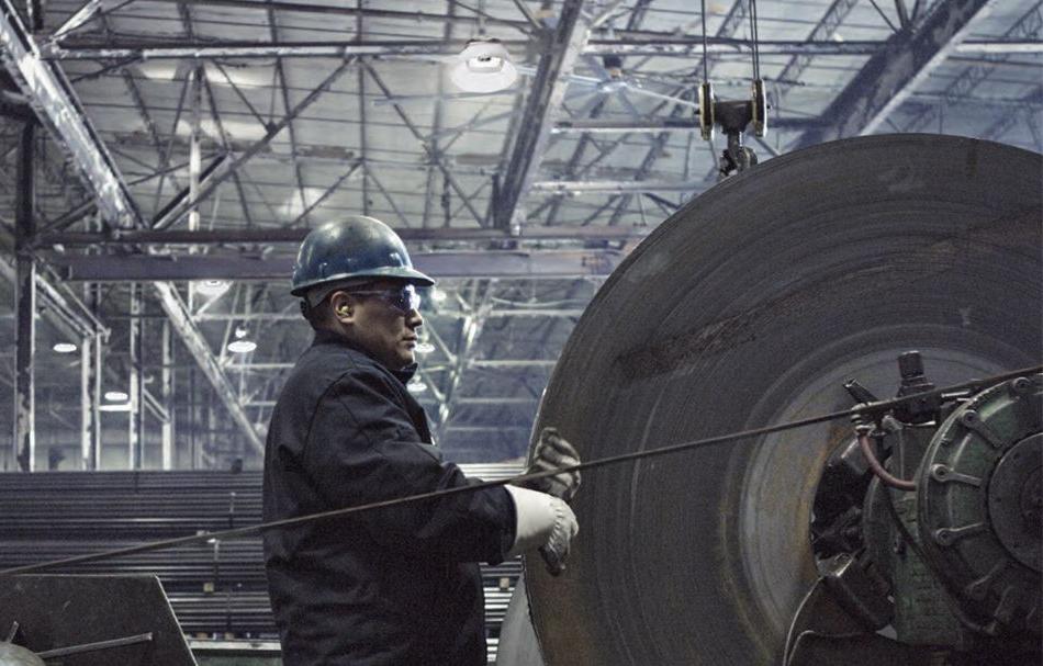 man working in a factory with high-bay lighting